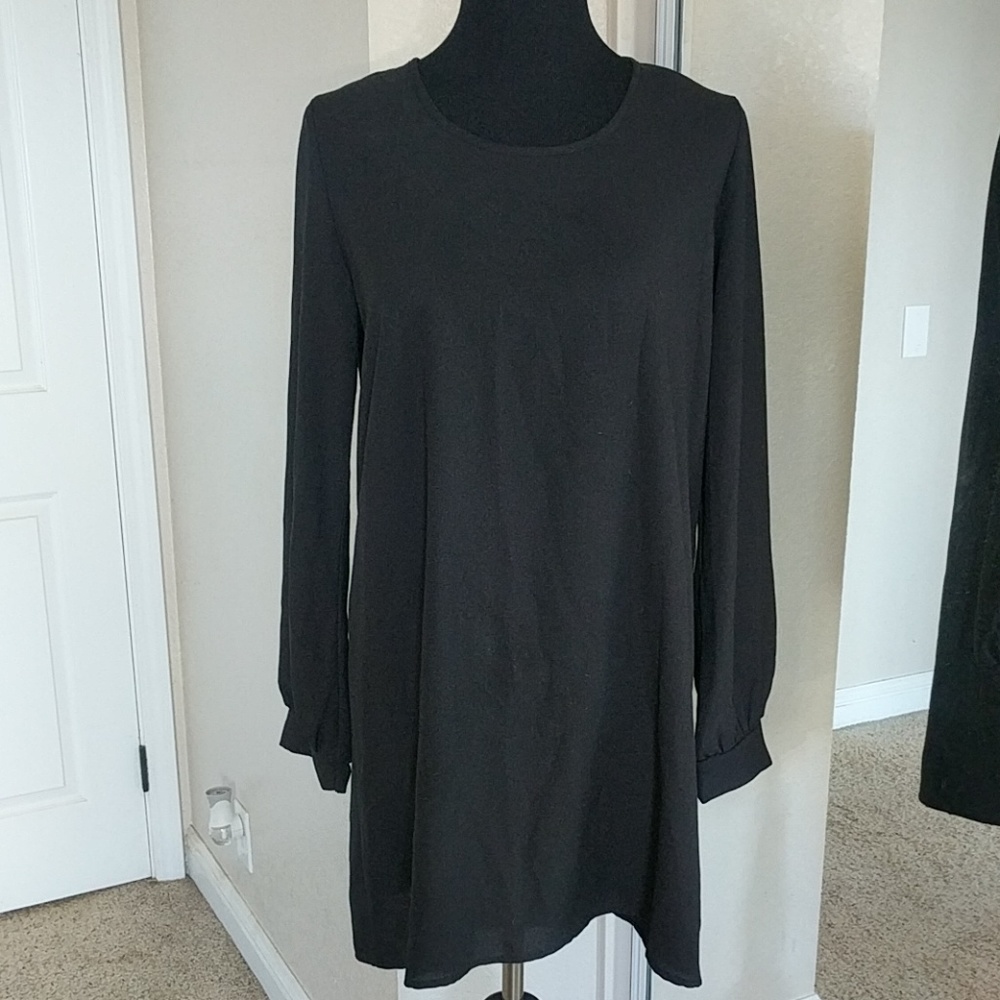 Long sleeve black dress with upper back cut out.